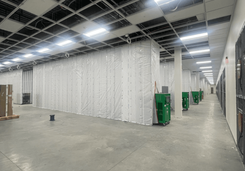 Healthcare facility under construction with cranes and workers